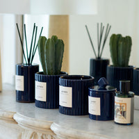 Le Poète refill bottle, at the end of a row of Le Poète candles and diffusers